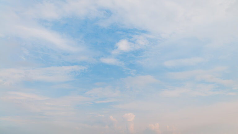 Blue sky surrounded by subtle clouds