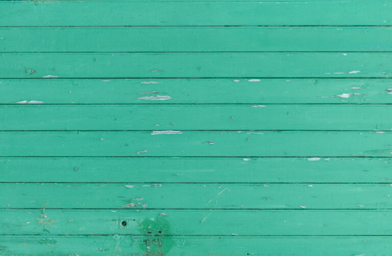 Eroded green wooden door landscape orientation