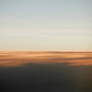 Vague sunrise projection on top of clouds